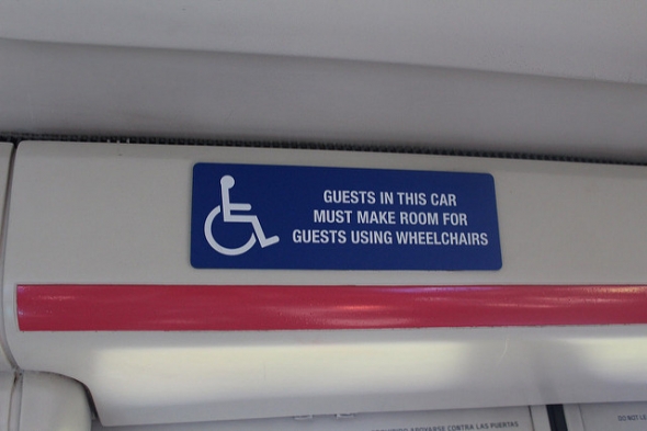 Sign for guests to give up seat for wheelchairs
