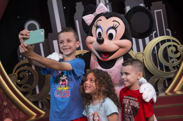 Young boys taking selfie with Mickey