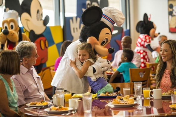 Chef Mickey hugging little girl