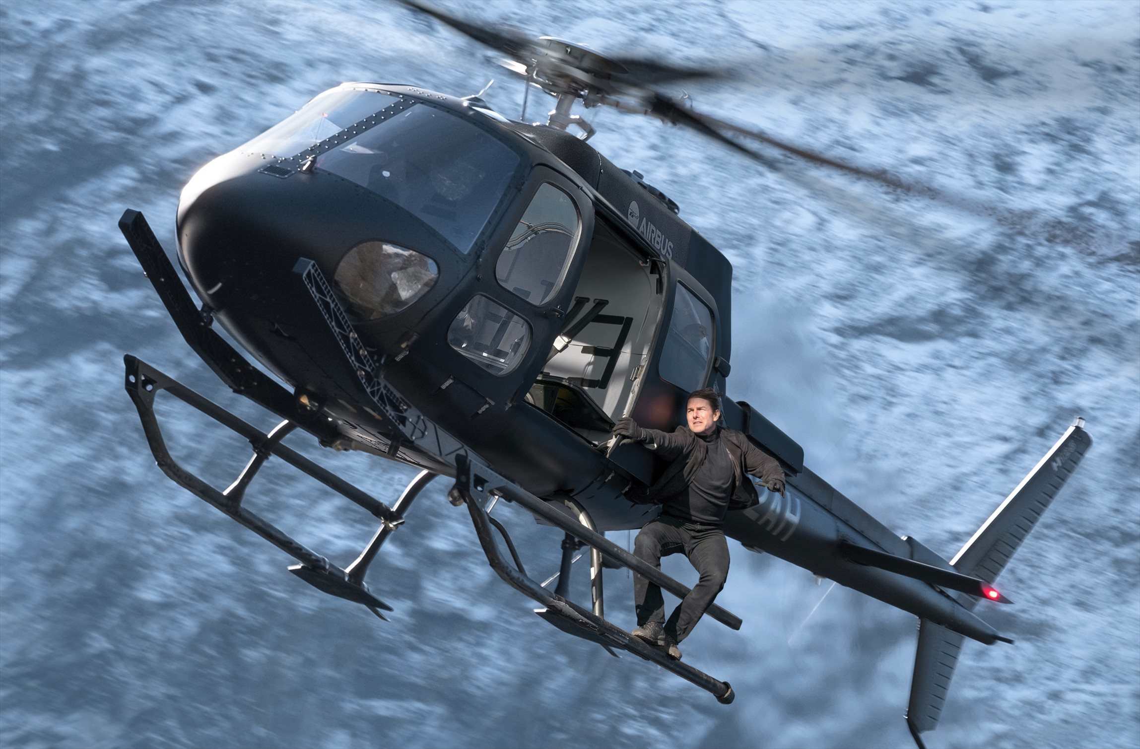 Tom Cruise hanging onto a helicopter