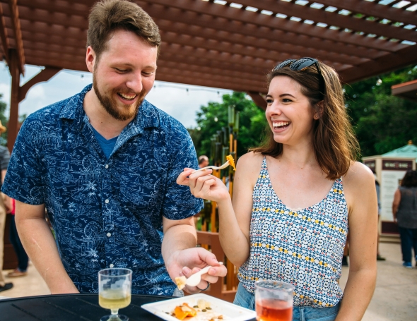 Happy couple enjoying food and wine festival