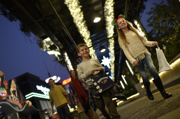 Kids smiling and walking together  celebrating at Epcot at night