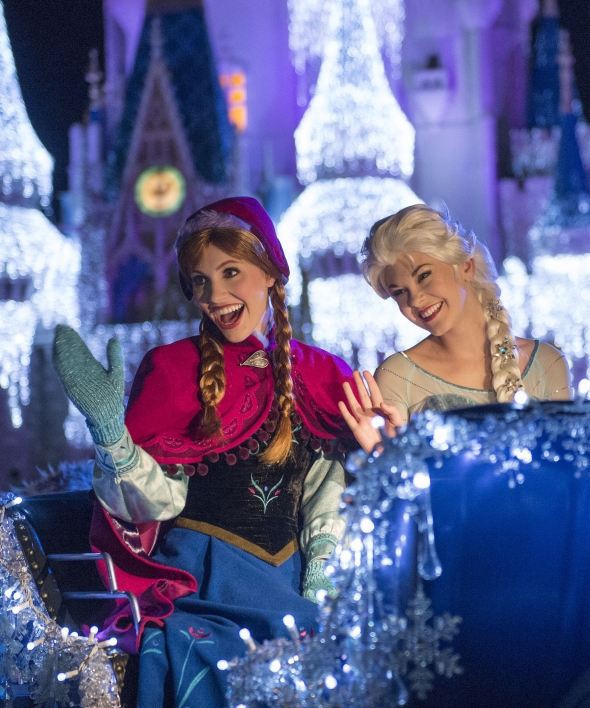 Anna and Elsa in parade sleigh