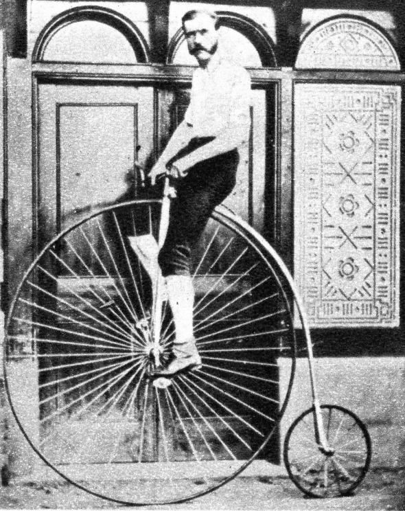 Man on old-timey high wheel bicycle