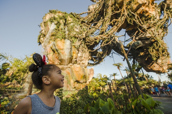 Girl with mouse ears looking up at floating islands at Pandora