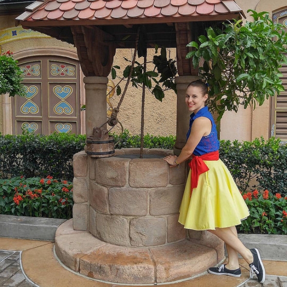 Girl by wishing well Disneybounding as Snow White