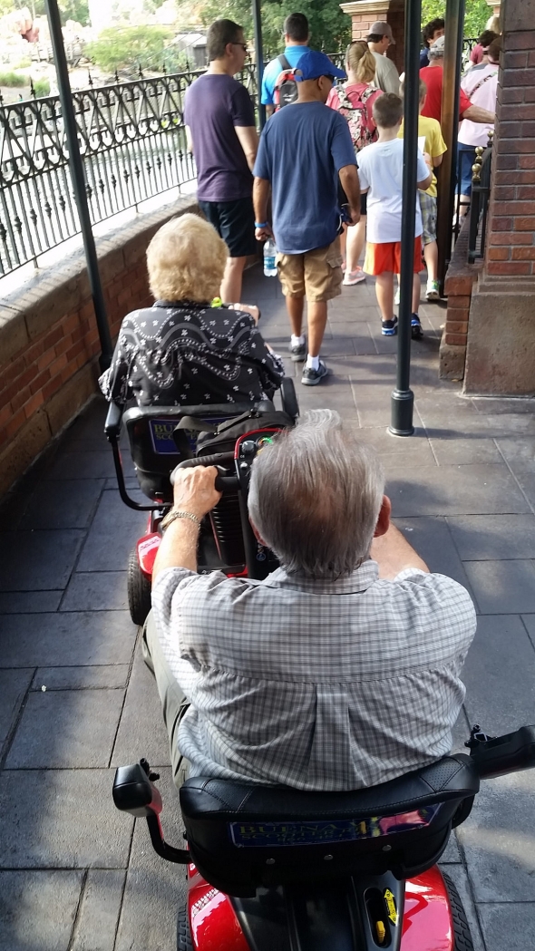 Elderly couple trying to drive scooters