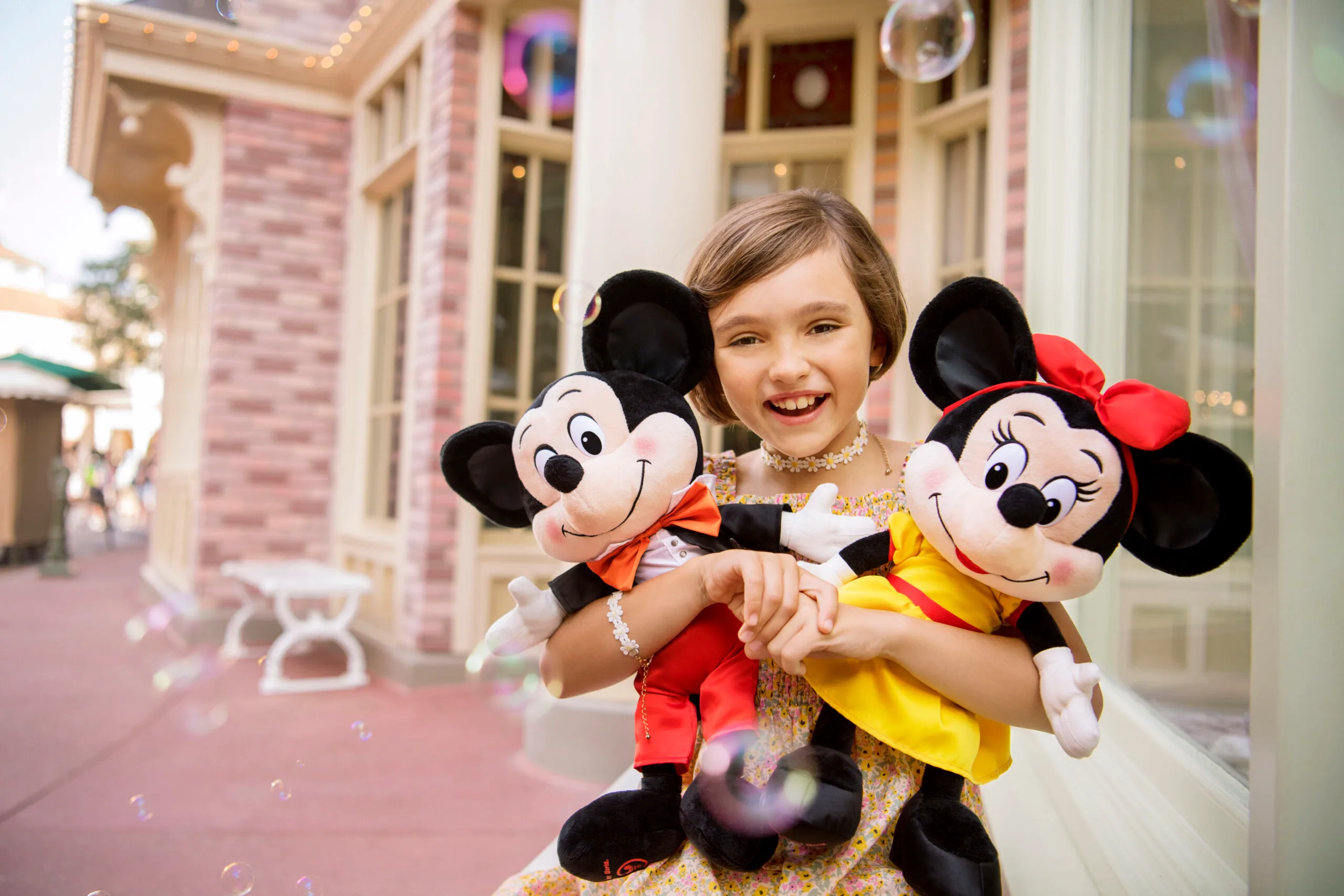 Little girl with Mickey and Minnie dolls